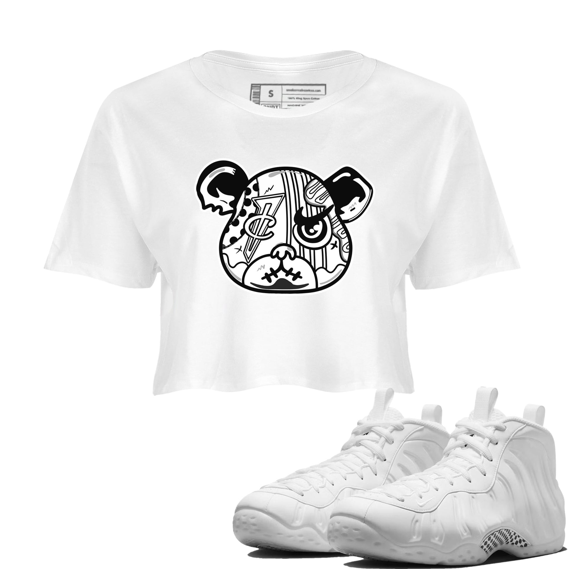 Sneaker Bear Face womens crop tee made to vibe with the Air Foamposite One Triple White sneakers — the perfect match in White 1.