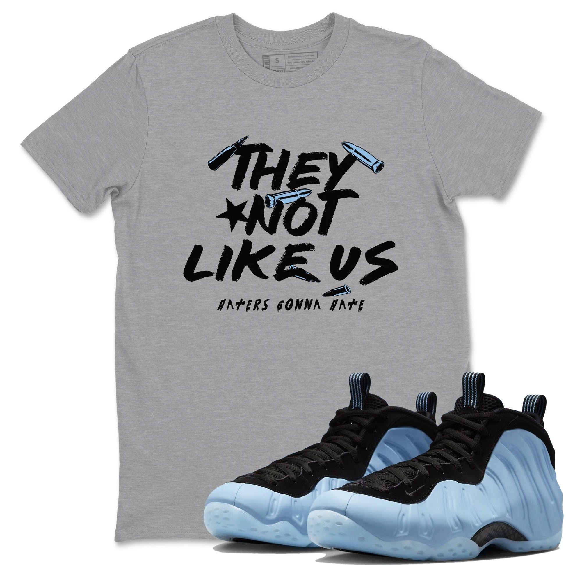 They Not Like Us sneaker match t-shirt styled to complete your fit with the Air Foamposite One Psychic Blue sneakers, shown in Heather Grey 1.