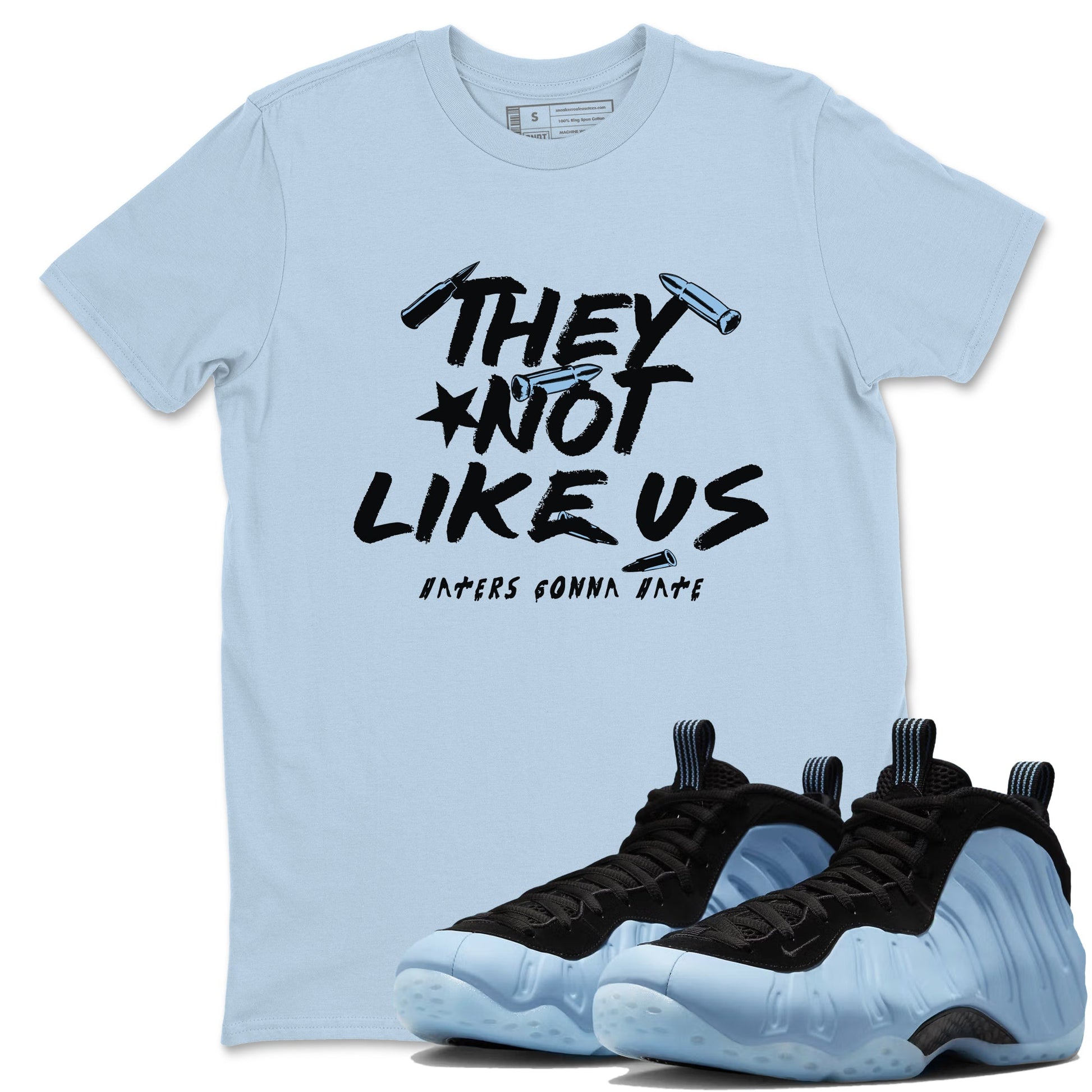 They Not Like Us sneaker match t-shirt styled to complete your fit with the Air Foamposite One Psychic Blue sneakers, shown in Light Blue 1.
