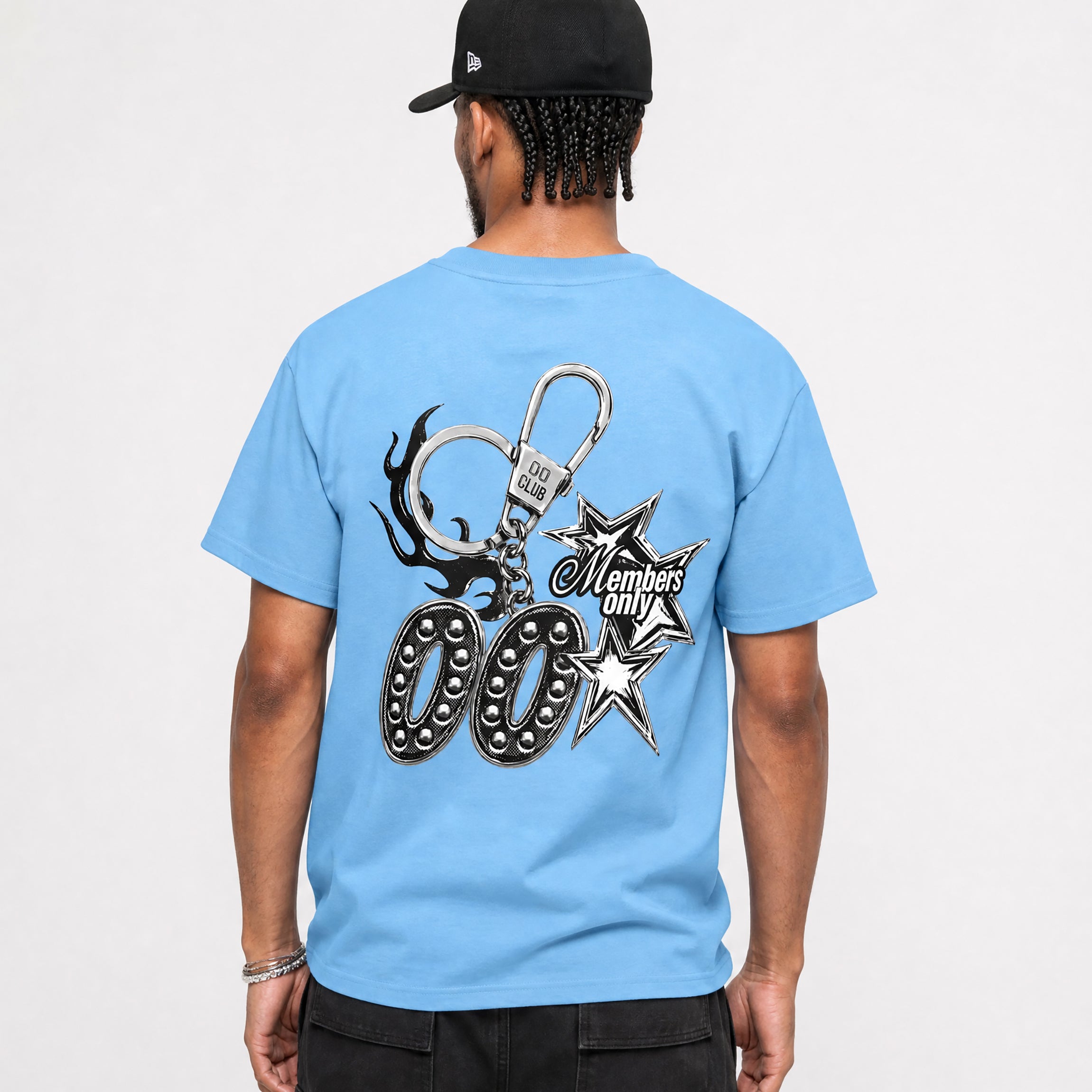 Person wearing a light blue t-shirt with a 00 members only keychain design on the back, on a plain background