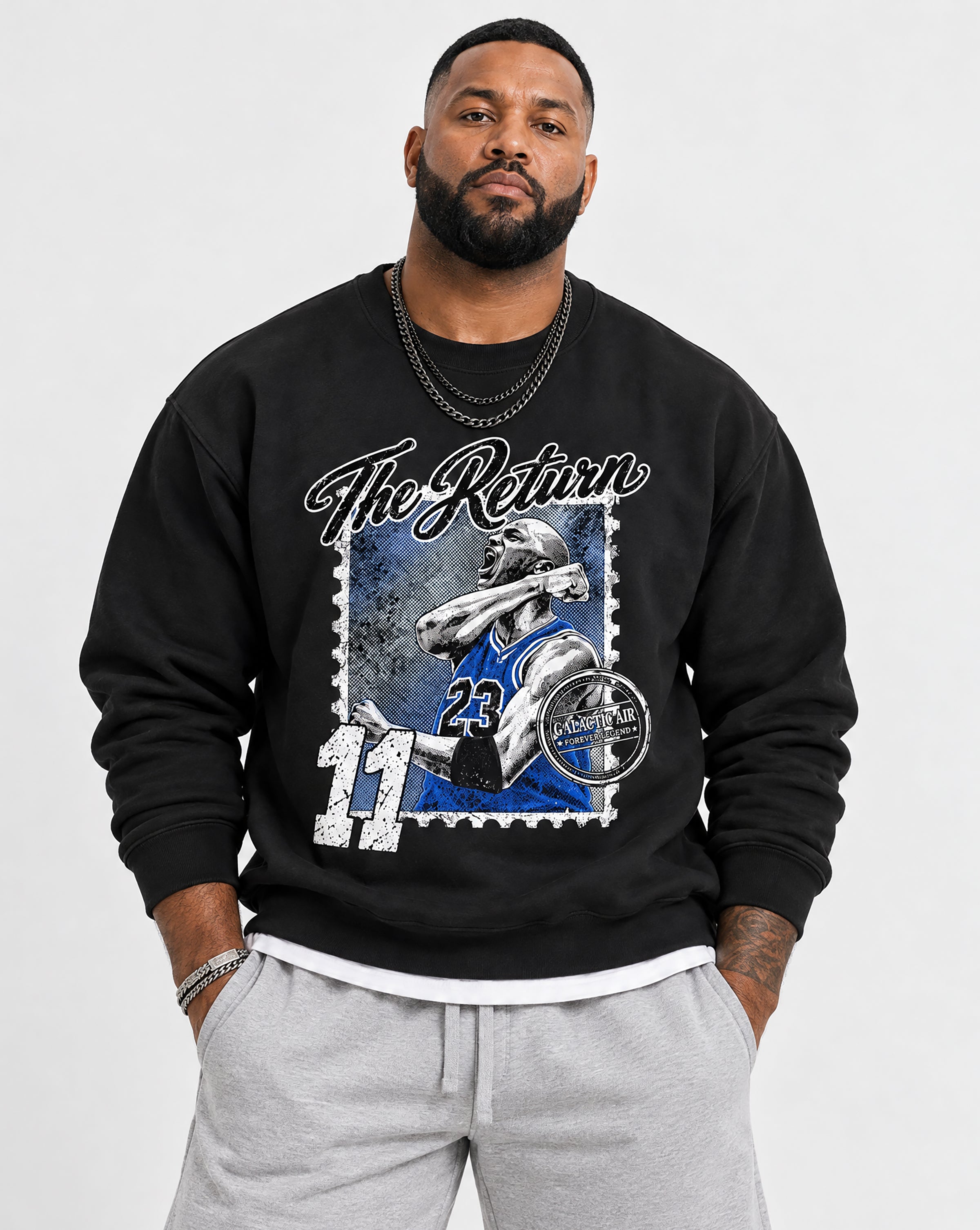 A man wearing a black crewneck sweatshirt with a large graphic print on the front. The graphic features a football player in a blue and white uniform inside a postage stamp design, with the text 'The Return' and the number '11'.