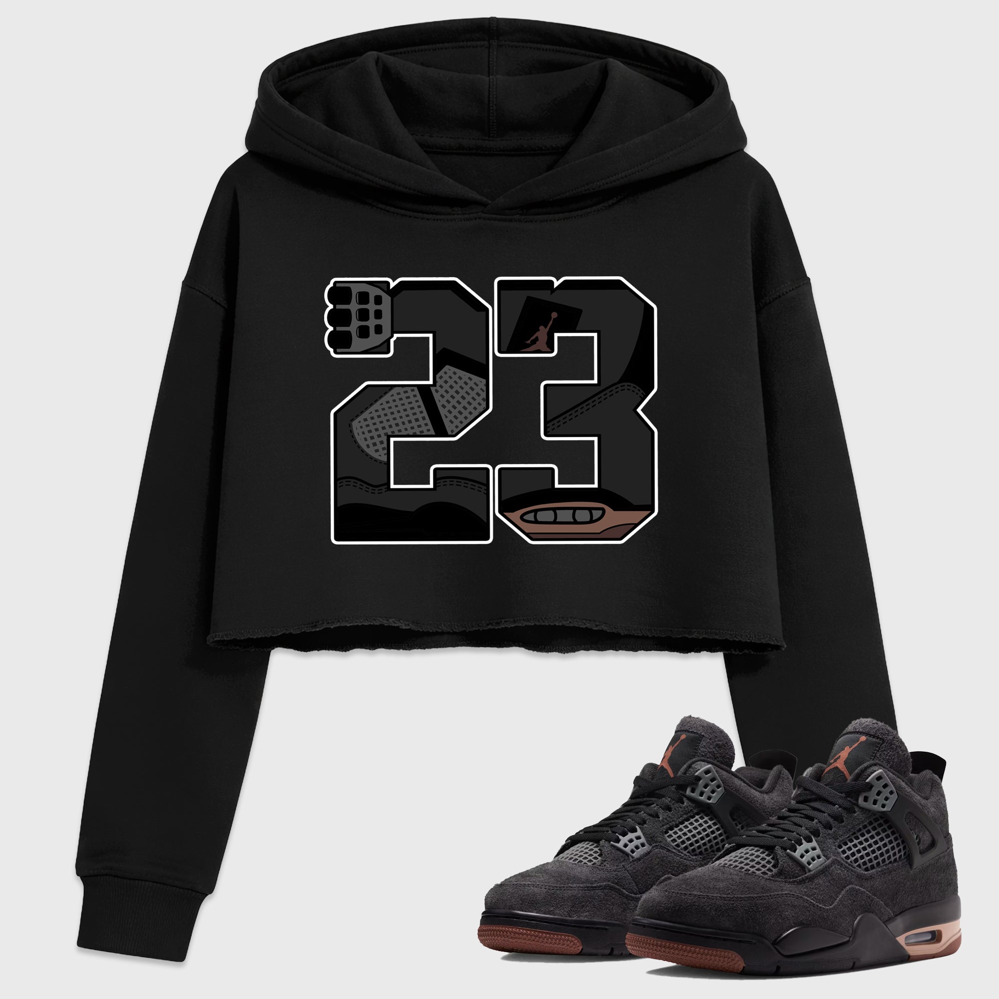 23 Women’s Graphic Crop Tee featuring original streetwear artwork designed to match the Air Jordan 4 London. Black 1 Crop Tee.
