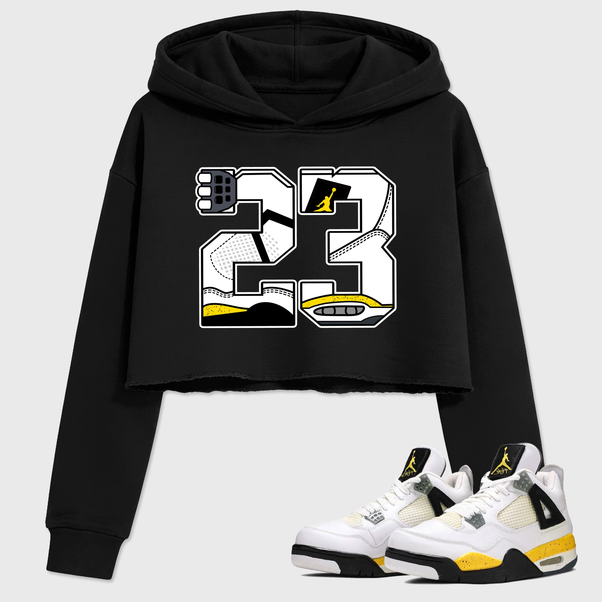 23 Women’s Graphic Crop Tee featuring original streetwear artwork designed to match the Air Jordan 4 Tour Yellow. Black 1 Crop Tee.
