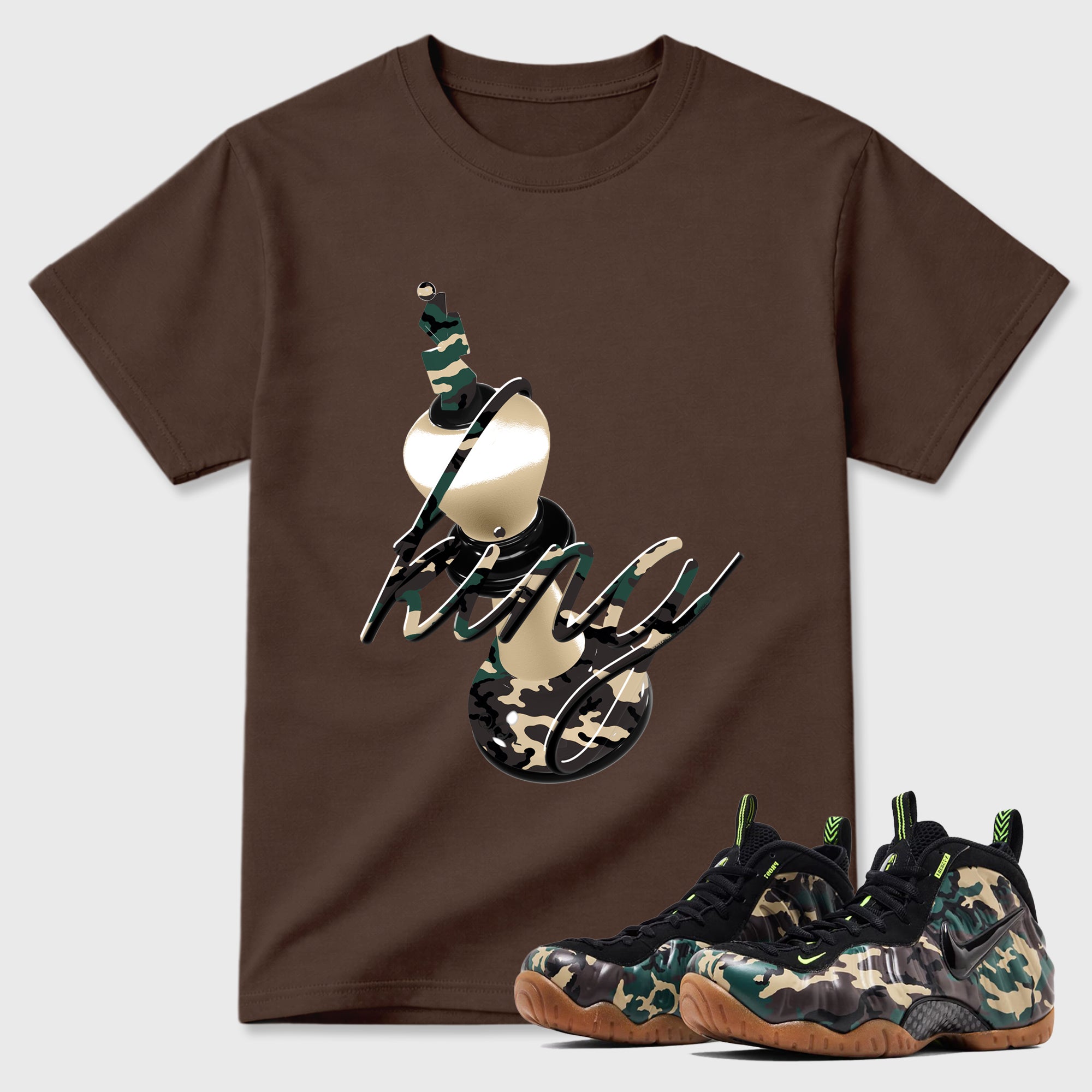 3D King Graphic T-Shirt featuring original streetwear artwork designed to match the Air Foamposite Pro Green Camo. Dark Chocolate 1 Graphic T-Shirt.