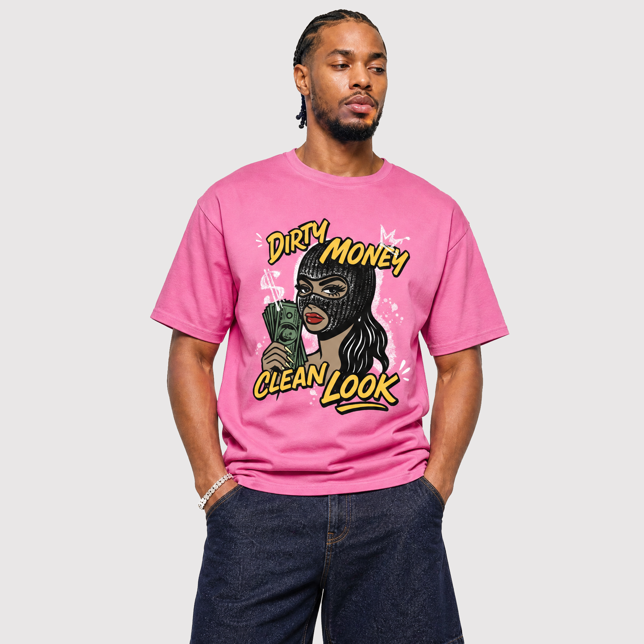 A man wearing a pink graphic t-shirt with a stylized illustration of a woman in a black mask holding cash, with the text 'DIRTY MONEY CLEAN LOOK'.