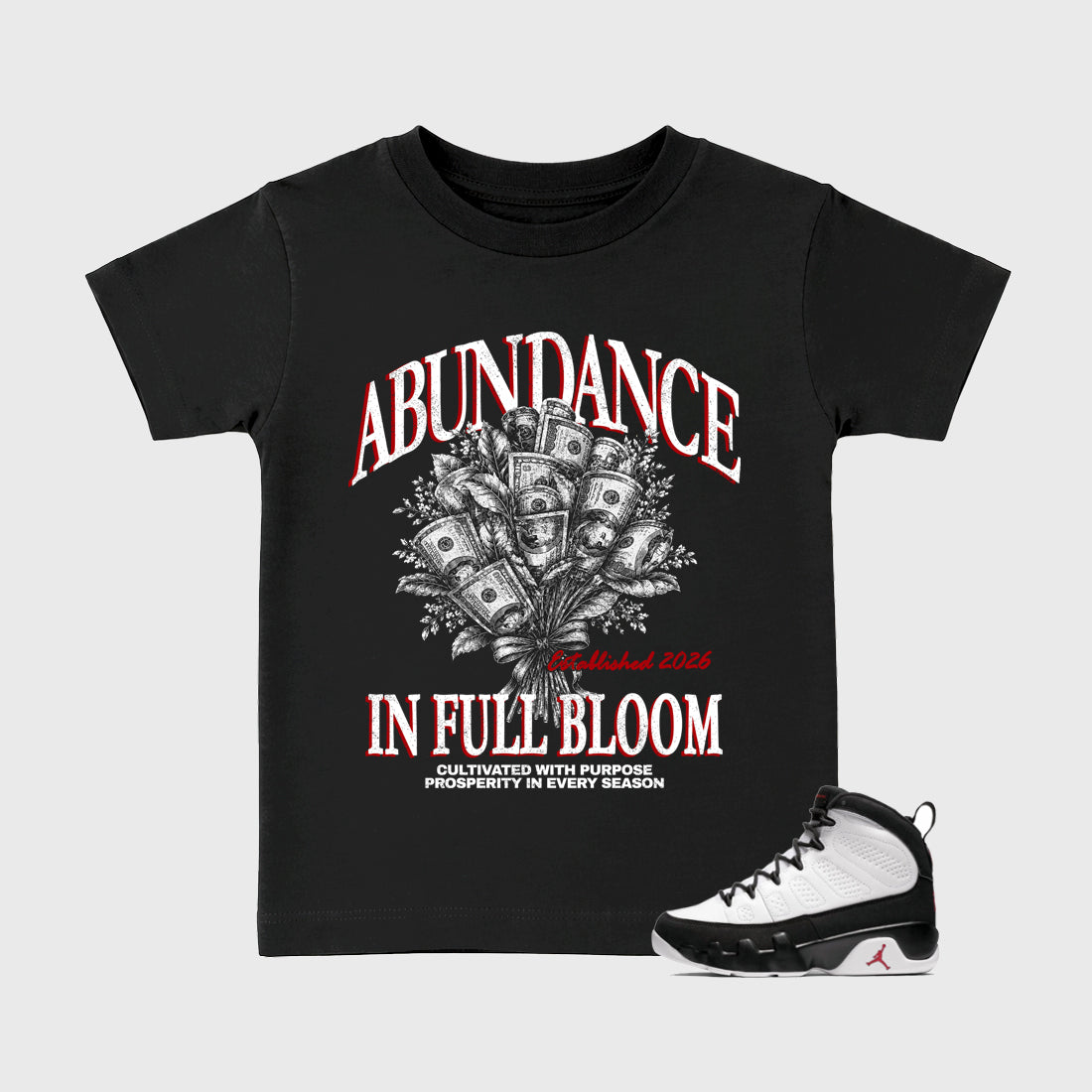 Abundance Baby & Kids Graphic T-Shirt featuring original artwork designed to match the Air Jordan 9 True Red. Black 1 Kids Graphic Tee.