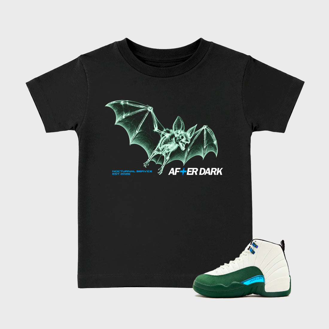 After Dark Baby & Kids Graphic T-Shirt featuring original artwork designed to match the Air Jordan 12 Summit Green. Black 1 Kids Graphic Tee.