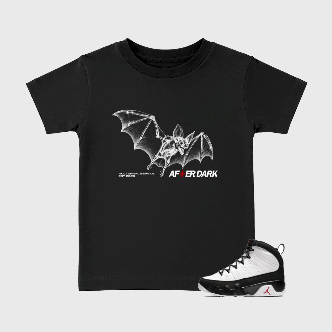 After Dark Baby & Kids Graphic T-Shirt featuring original artwork designed to match the Air Jordan 9 True Red. Black 1 Kids Graphic Tee.