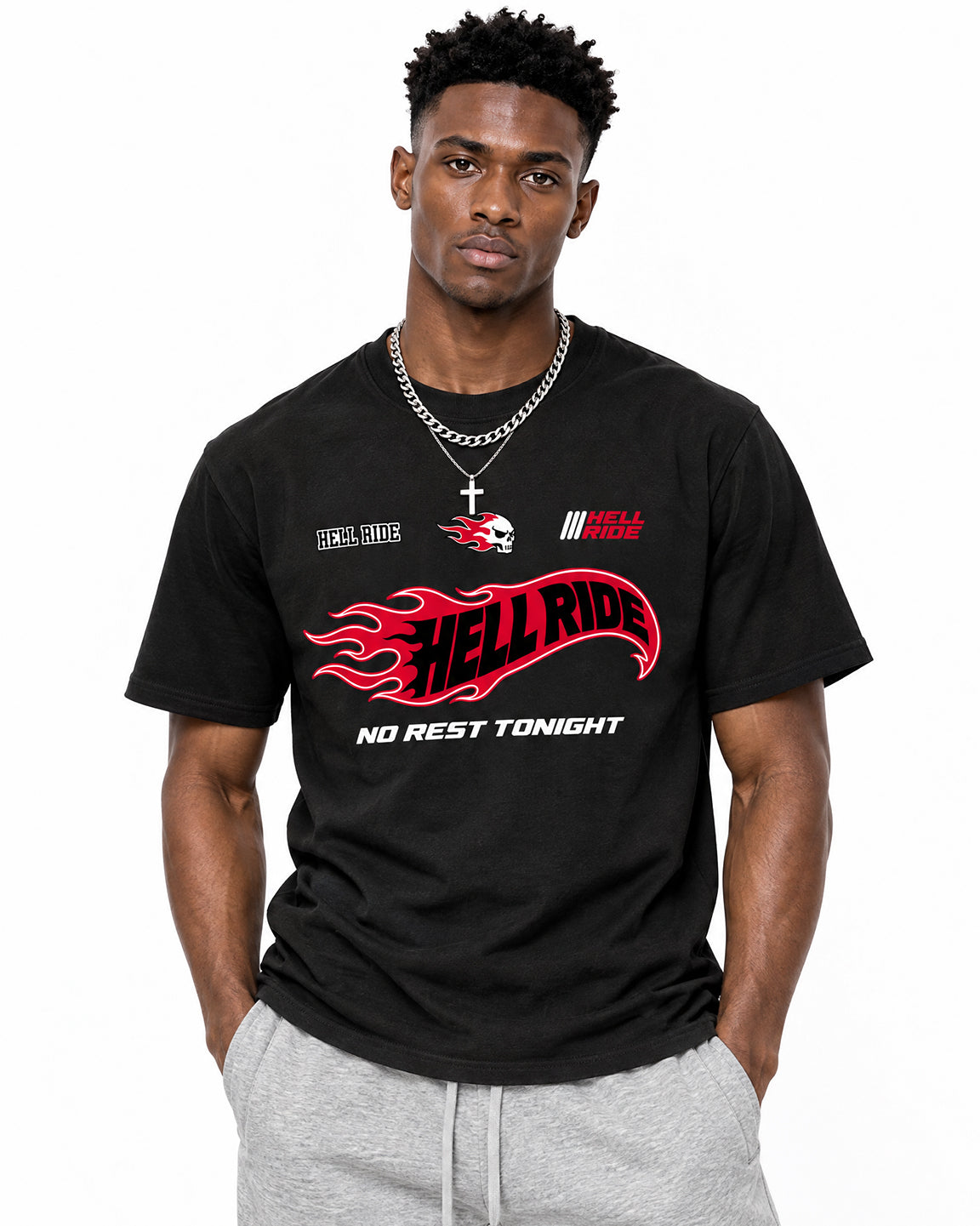 A man wearing a black t-shirt with a red and white 'Hell Ride' graphic, paired with gray sweatpants, photographed against a solid white background.
