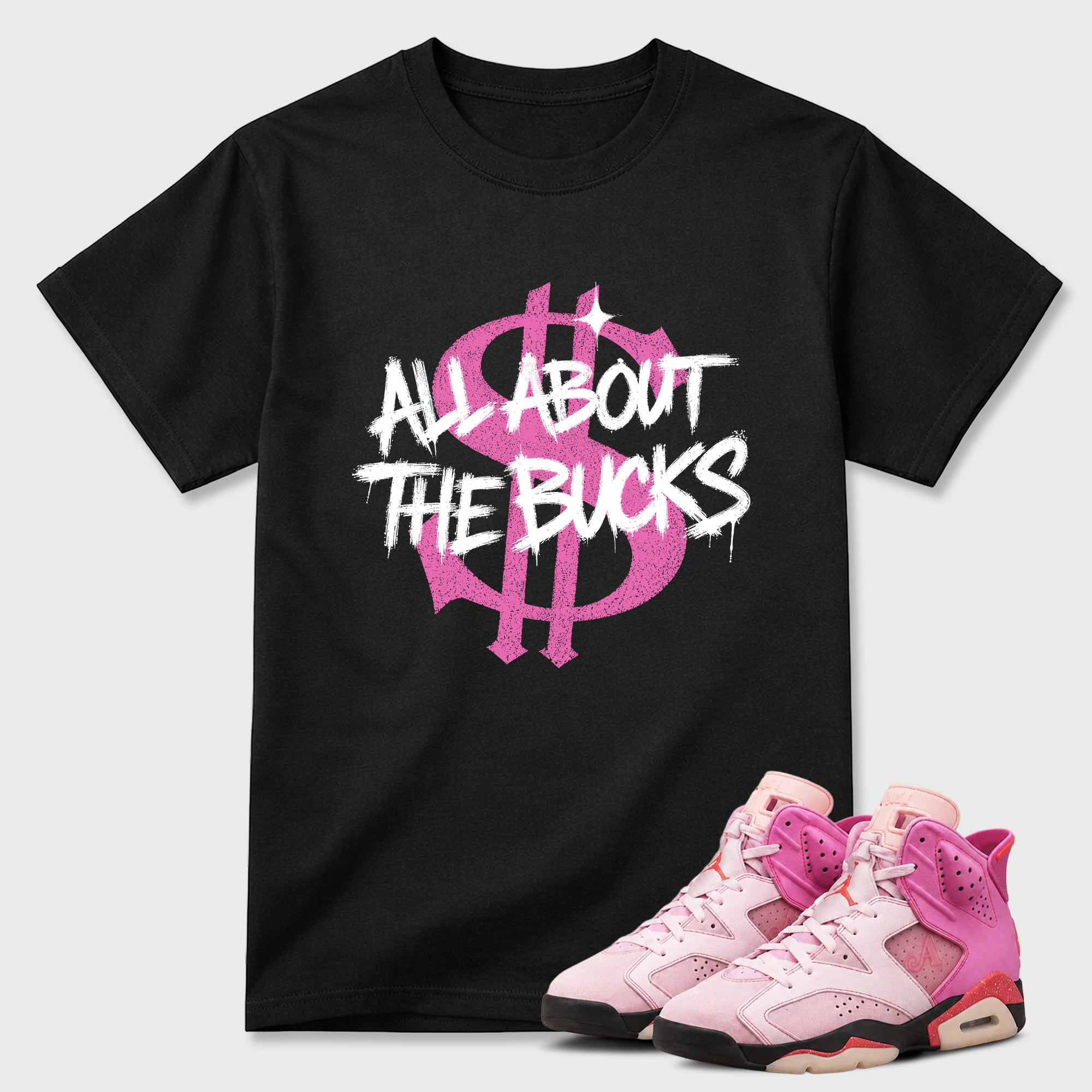 All About the Bucks Graphic T-Shirt featuring original streetwear artwork designed to match the Air Jordan 6 Playful Pink. Black 1 Graphic T-Shirt.
