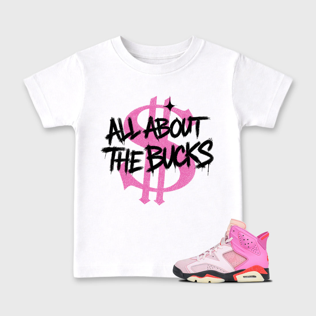 All About the Bucks Baby & Kids Graphic T-Shirt featuring original artwork designed to match the Air Jordan 6 Playful Pink. White 1 Kids Graphic Tee.