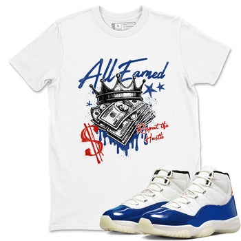White t-shirt with graphic design and blue and white sneakers on a white background