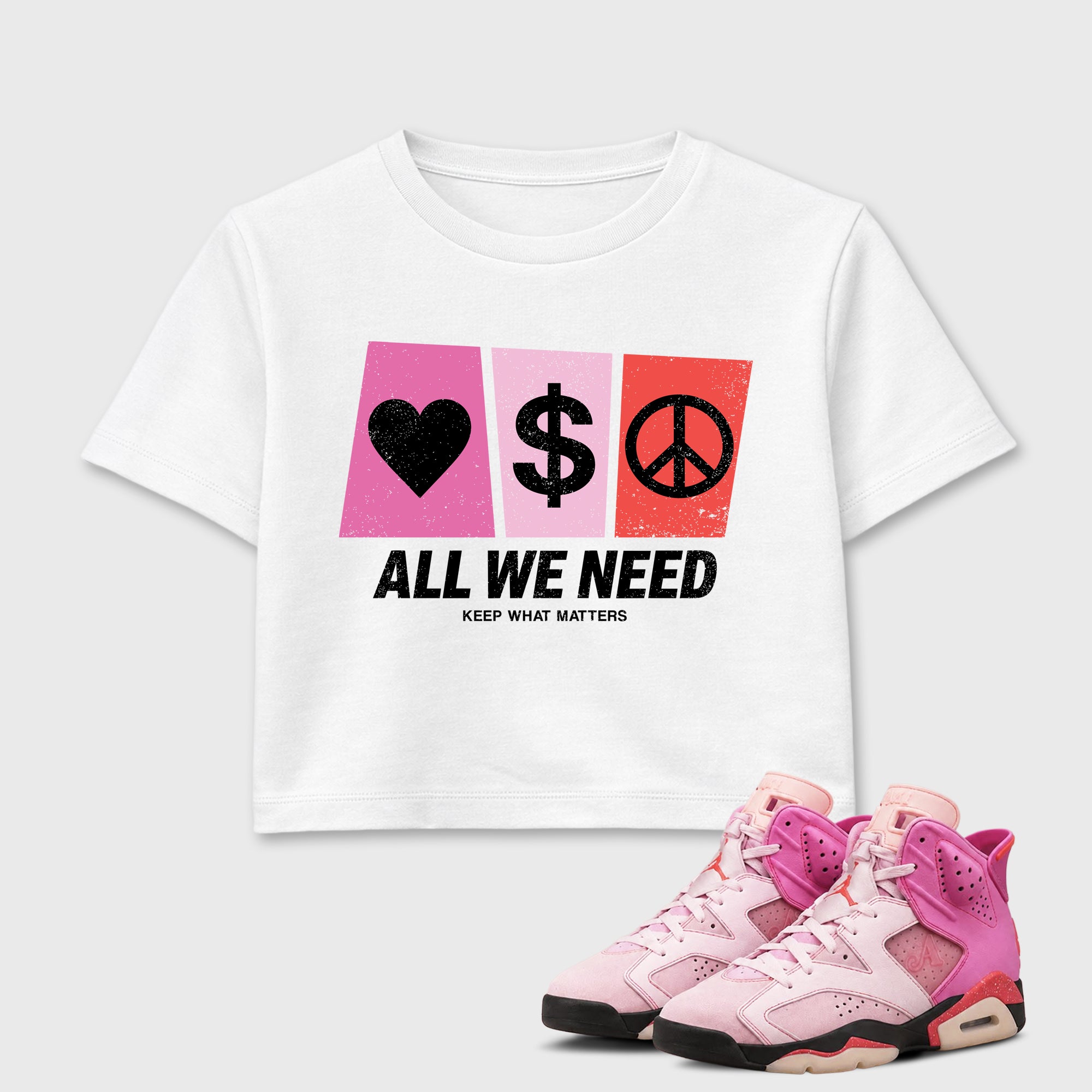 All We Need women_ crop tee designed to match the Air Jordan 6 Playful Pink, featuring coordinated White 1 options for a perfect streetwear vibe.