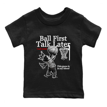 Ball First Talk Later baby and kids t-shirt crafted for little sneakerheads to shine with the Air Jordan 4 White Cement sneakers, displayed in Black 2.