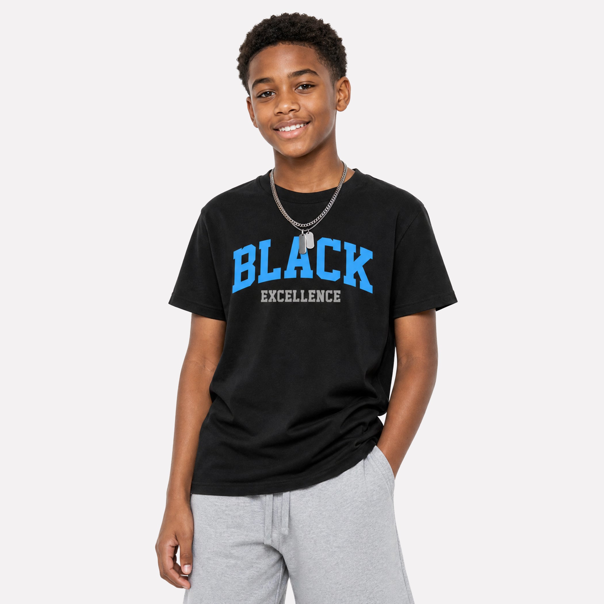 A young man wearing a black t-shirt with 'BLACK EXCELLENCE' printed in blue and white on the front, paired with light gray sweatpants, against a light gray background.