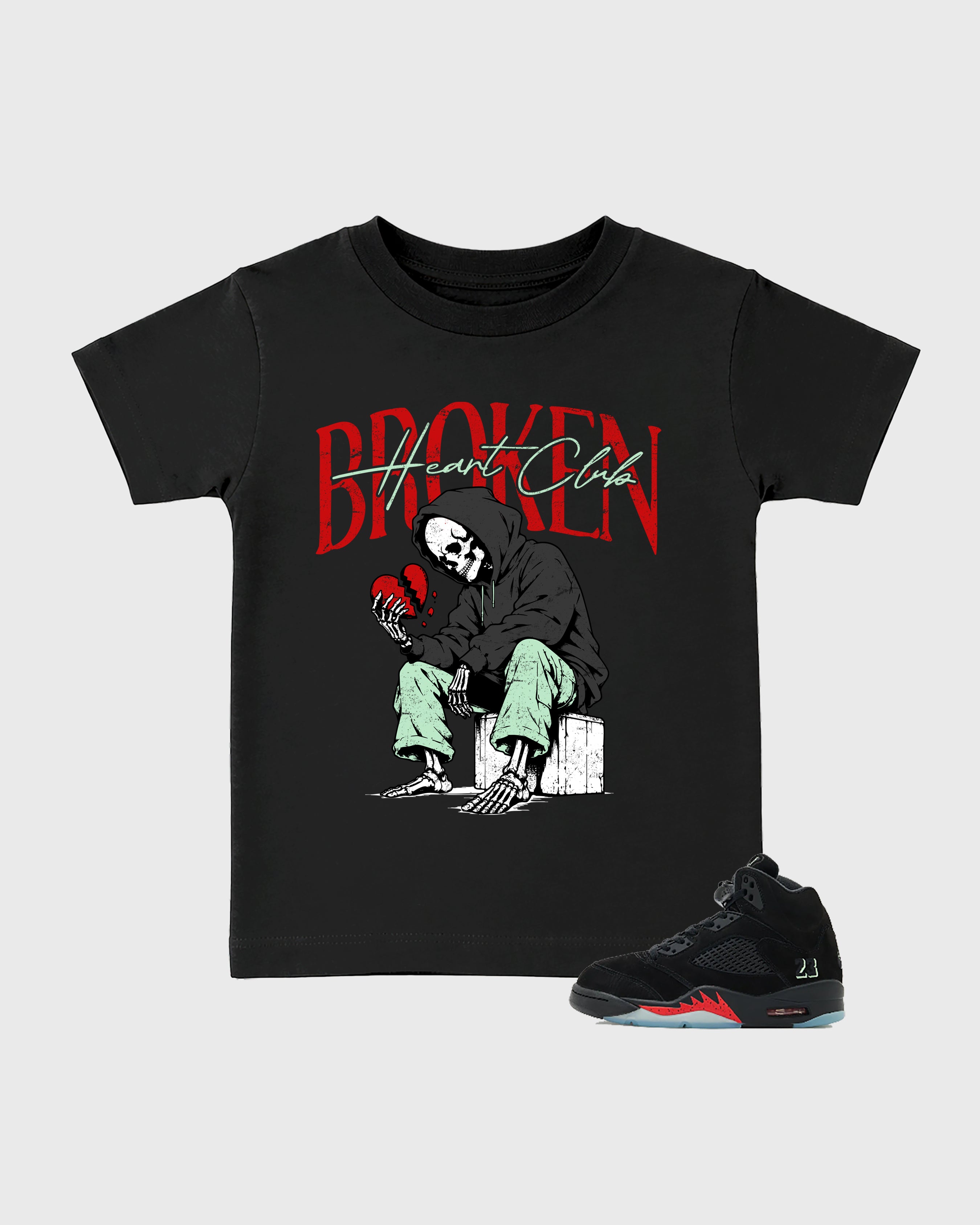 Broken Heart Club Baby & Kids Graphic T-Shirt featuring original artwork designed to match the Air Jordan 5 Halloween. Black 1 Kids Graphic Tee.