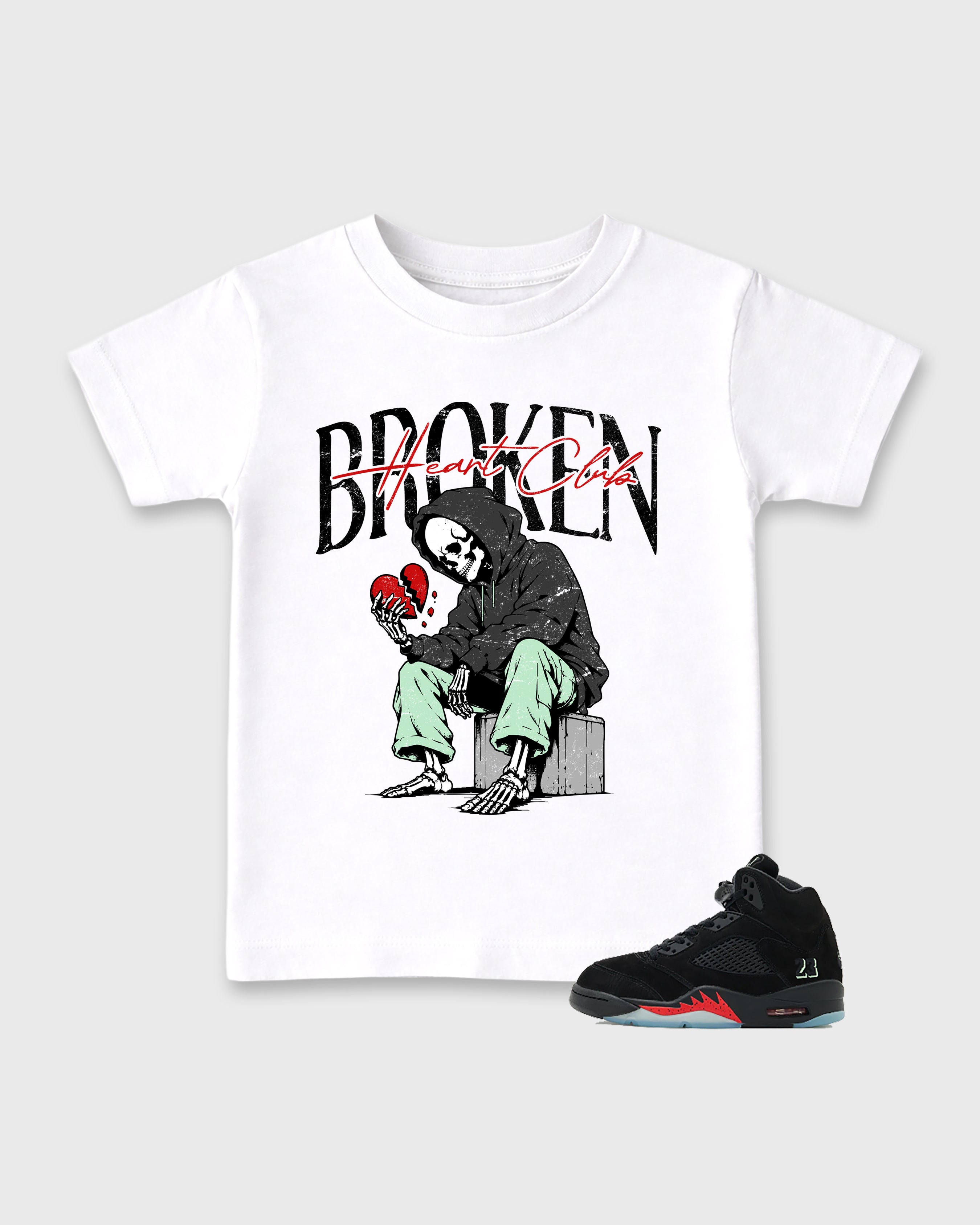 Broken Heart Club Baby & Kids Graphic T-Shirt featuring original artwork designed to match the Air Jordan 5 Halloween. White 1 Kids Graphic Tee.