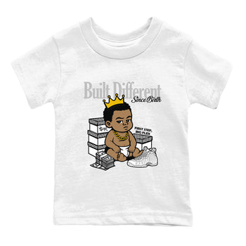 Built Different Since Birth baby and kids t-shirt crafted for little sneakerheads to shine with the Air Foamposite One Triple White sneakers, displayed in White 2.