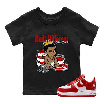 Built Different Since Birth baby and kids t-shirt crafted for little sneakerheads to shine with the Air Force 1 University Red sneakers, displayed in Black 1.