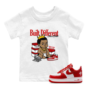 Built Different Since Birth baby and kids t-shirt crafted for little sneakerheads to shine with the Air Force 1 University Red sneakers, displayed in White 1.