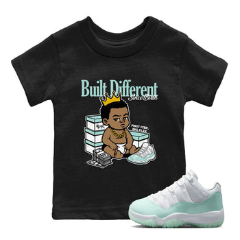 Built Different Since Birth baby and kids t-shirt crafted for little sneakerheads to shine with the Air Jordan 11 Igloo sneakers, displayed in Black 1.