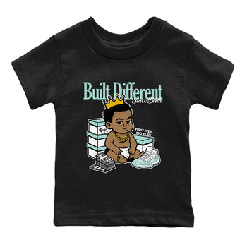 Built Different Since Birth baby and kids t-shirt crafted for little sneakerheads to shine with the Air Jordan 11 Igloo sneakers, displayed in Black 2.