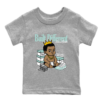 Built Different Since Birth baby and kids t-shirt crafted for little sneakerheads to shine with the Air Jordan 11 Igloo sneakers, displayed in Heather Grey 2.