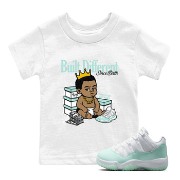 Built Different Since Birth baby and kids t-shirt crafted for little sneakerheads to shine with the Air Jordan 11 Igloo sneakers, displayed in White 1.