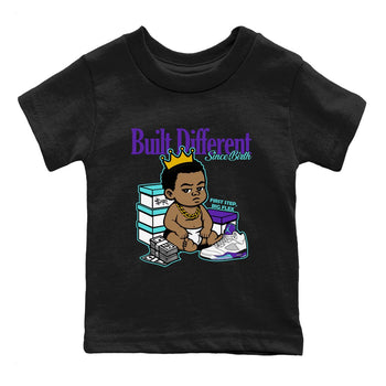 Built Different Since Birth baby and kids t-shirt crafted for little sneakerheads to shine with the Air Jordan 5 Grape sneakers, displayed in Black 2.