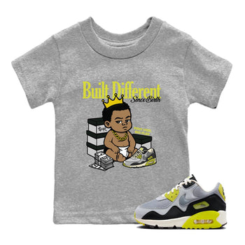 Built Different Since Birth baby and kids t-shirt crafted for little sneakerheads to shine with the Air Max 90 Cyber sneakers, displayed in Heather Grey 1.