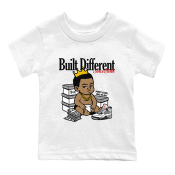 Bulit Different Since Birth baby and kids t-shirt crafted for little sneakerheads to shine with the Air Jordan 4 White Cement sneakers, displayed in White 2.