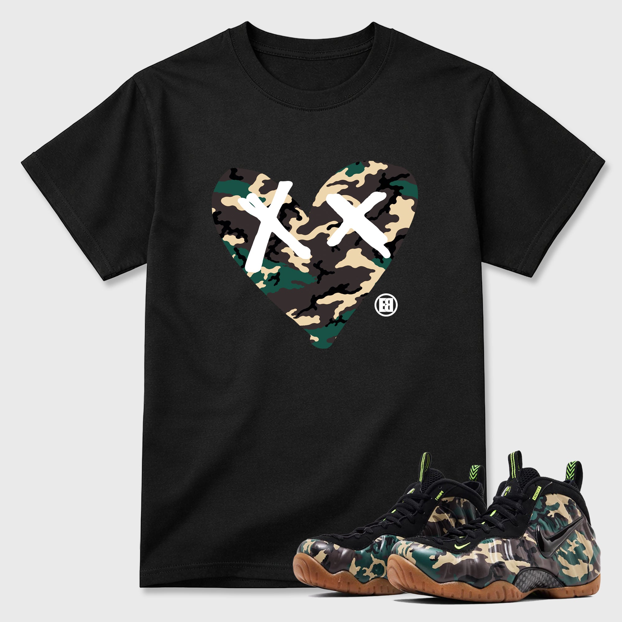 Camo Heart Graphic T-Shirt featuring original streetwear artwork designed to match the Air Foamposite Pro Green Camo. Black 1 Graphic T-Shirt.