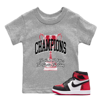 Champions Trophy baby and kids t-shirt crafted for little sneakerheads to shine with the Air Jordan 1 Ruby sneakers, displayed in Heather Grey 1.