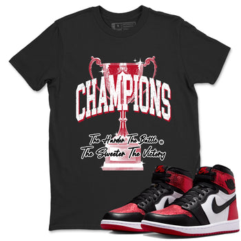 Champions Trophy sneaker match t-shirt styled to complete your fit with the Air Jordan 1 Ruby sneakers, shown in Black 1.