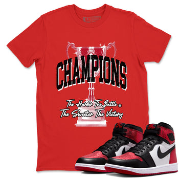 Champions Trophy sneaker match t-shirt styled to complete your fit with the Air Jordan 1 Ruby sneakers, shown in Red 1.