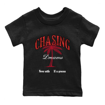 Chasing Dreams baby and kids t-shirt crafted for little sneakerheads to shine with the Air Jordan 1 Ruby sneakers, displayed in Black 2.