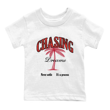 Chasing Dreams baby and kids t-shirt crafted for little sneakerheads to shine with the Air Jordan 1 Ruby sneakers, displayed in White 2.