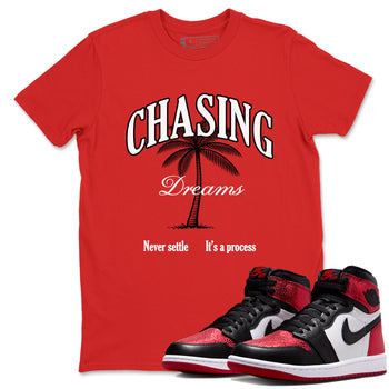 Chasing Dreams sneaker match t-shirt styled to complete your fit with the Air Jordan 1 Ruby sneakers, shown in Red 1.