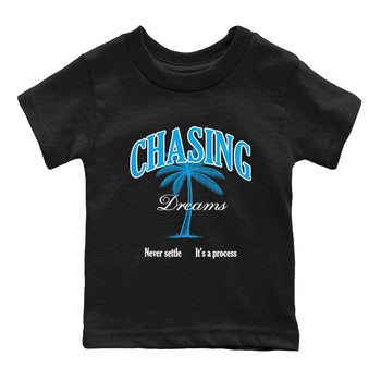 Chasing Dreams baby and kids t-shirt crafted for little sneakerheads to shine with the Air Jordan 1 UNC Reimagined sneakers, displayed in Black 2.