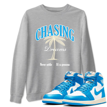 Chasing Dreams sneaker match t-shirt styled to complete your fit with the Air Jordan 1 UNC Reimagined sneakers, shown in Heather Grey 1.