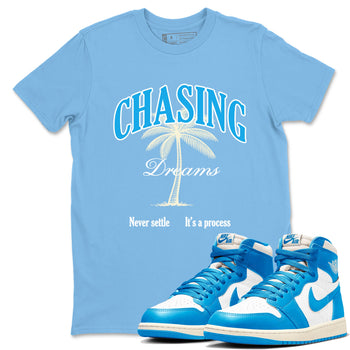 Chasing Dreams sneaker match t-shirt styled to complete your fit with the Air Jordan 1 UNC Reimagined sneakers, shown in Carolina Blue 1.