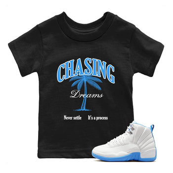 Chasing Dreams baby and kids t-shirt crafted for little sneakerheads to shine with the Air Jordan 12 White and University Blue sneakers, displayed in Black 1.