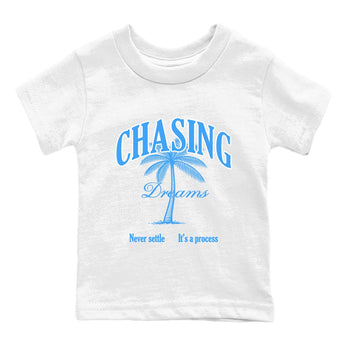 Chasing Dreams baby and kids t-shirt crafted for little sneakerheads to shine with the Air Jordan 12 White and University Blue sneakers, displayed in White 2.