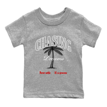 Chasing Dreams baby and kids t-shirt crafted for little sneakerheads to shine with the Air Jordan 4 White Cement sneakers, displayed in Heather Grey 2.