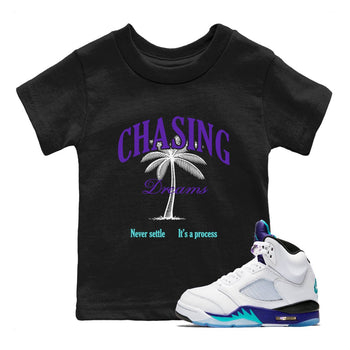 Chasing Dreams baby and kids t-shirt crafted for little sneakerheads to shine with the Air Jordan 5 Grape sneakers, displayed in Black 1.