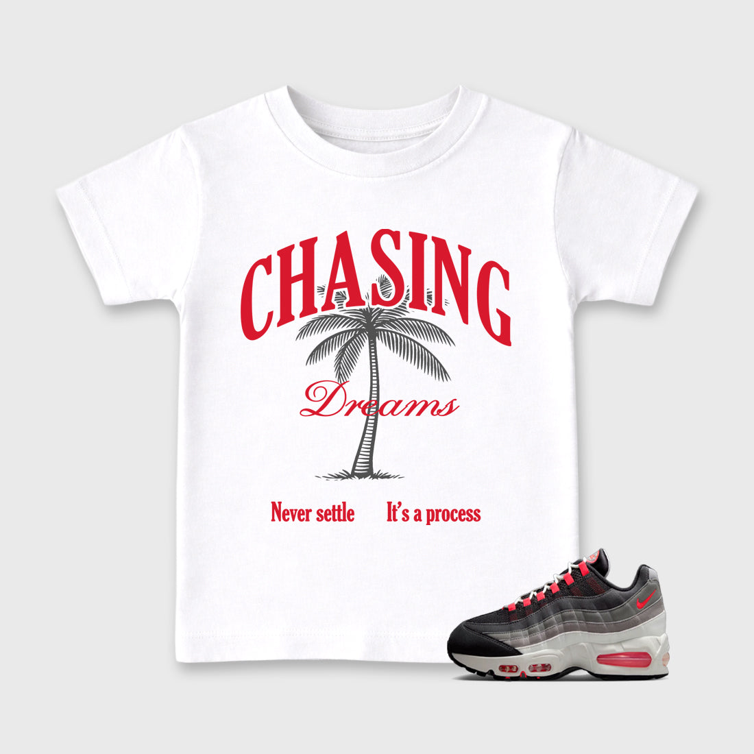 Chasing Dreams Baby & Kids Graphic T-Shirt featuring original artwork designed to match the Air Max 95 Reverse Solar Red. White 1 Kids Graphic Tee.