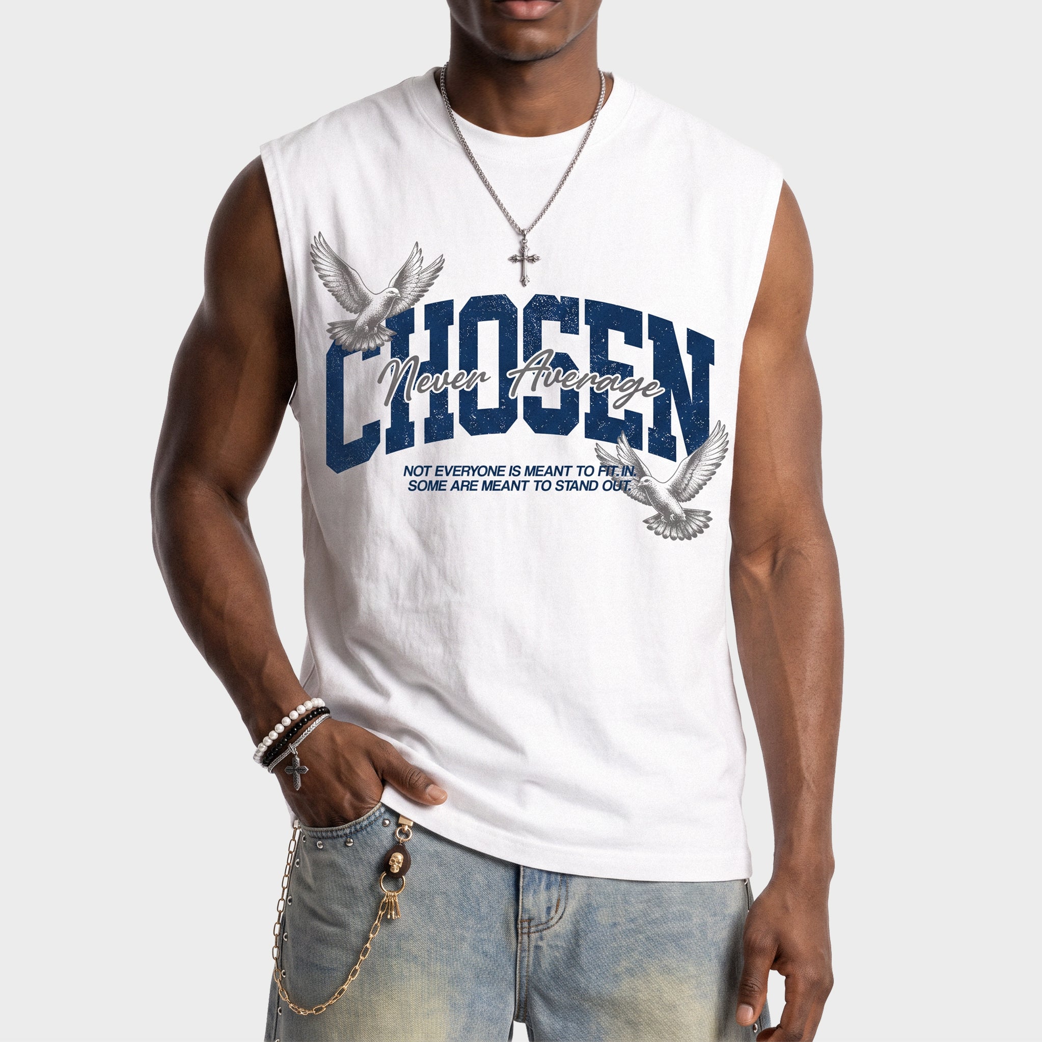 A man wearing a white sleeveless muscle t-shirt with a blue and gray graphic that reads 'CHOSEN' and 'Never Average' with two doves, paired with light blue jeans against a light gray background.
