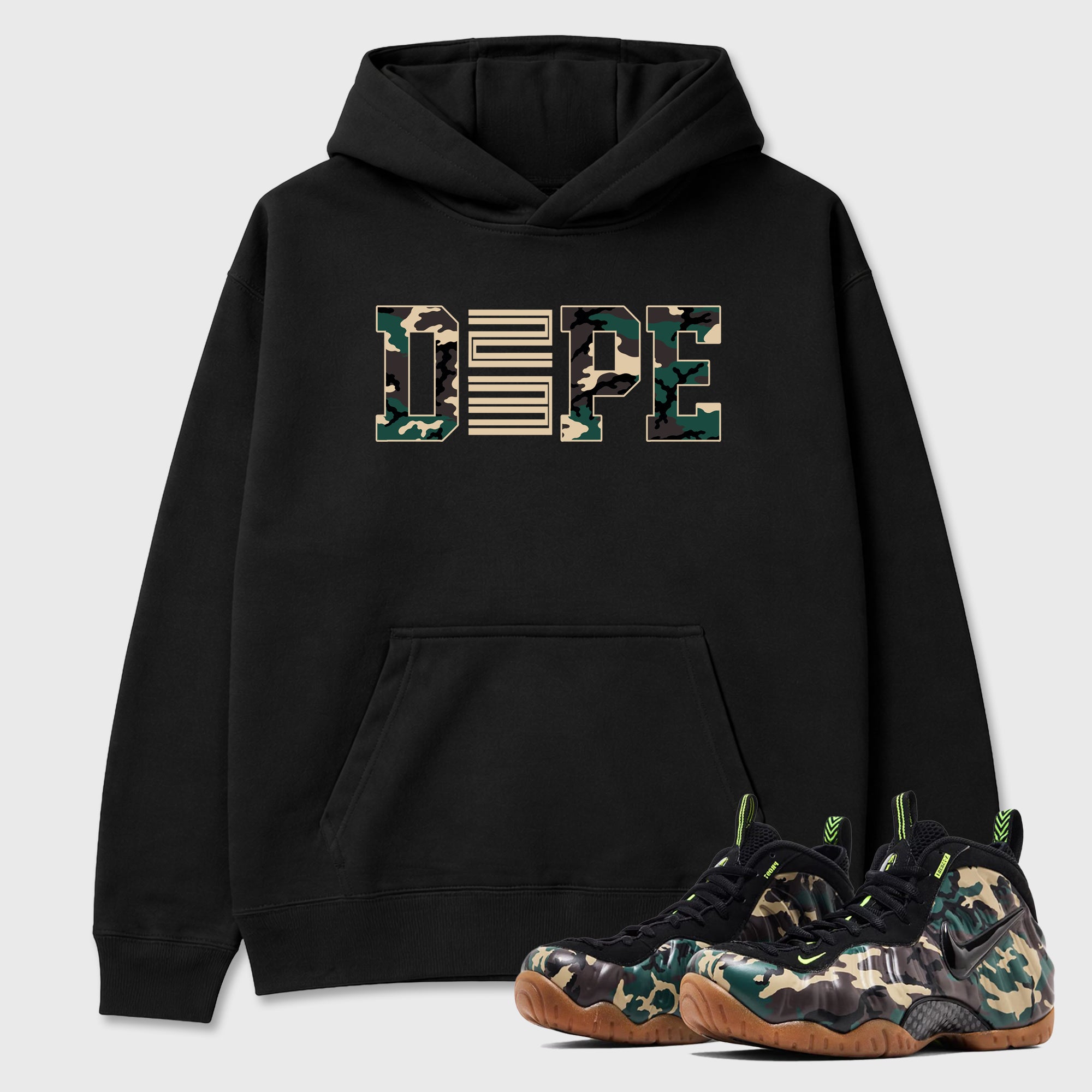 Dope 23 Graphic T-Shirt featuring original streetwear artwork designed to match the Air Foamposite Pro Green Camo. Black 1 Graphic Tee.