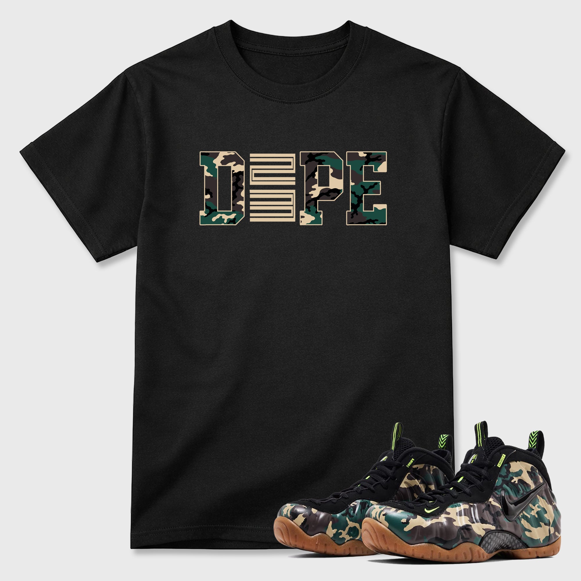 Dope 23 Graphic T-Shirt featuring original streetwear artwork designed to match the Air Foamposite Pro Green Camo. Black 1 Graphic T-Shirt.
