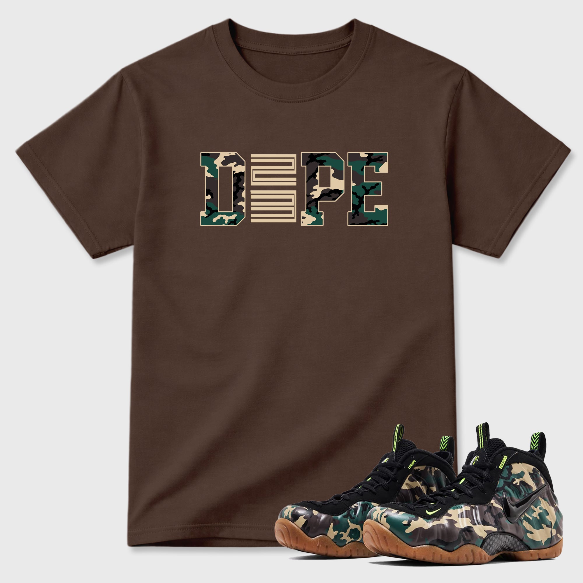 Dope 23 Graphic T-Shirt featuring original streetwear artwork designed to match the Air Foamposite Pro Green Camo. Dark Chocolate 1 Graphic T-Shirt.